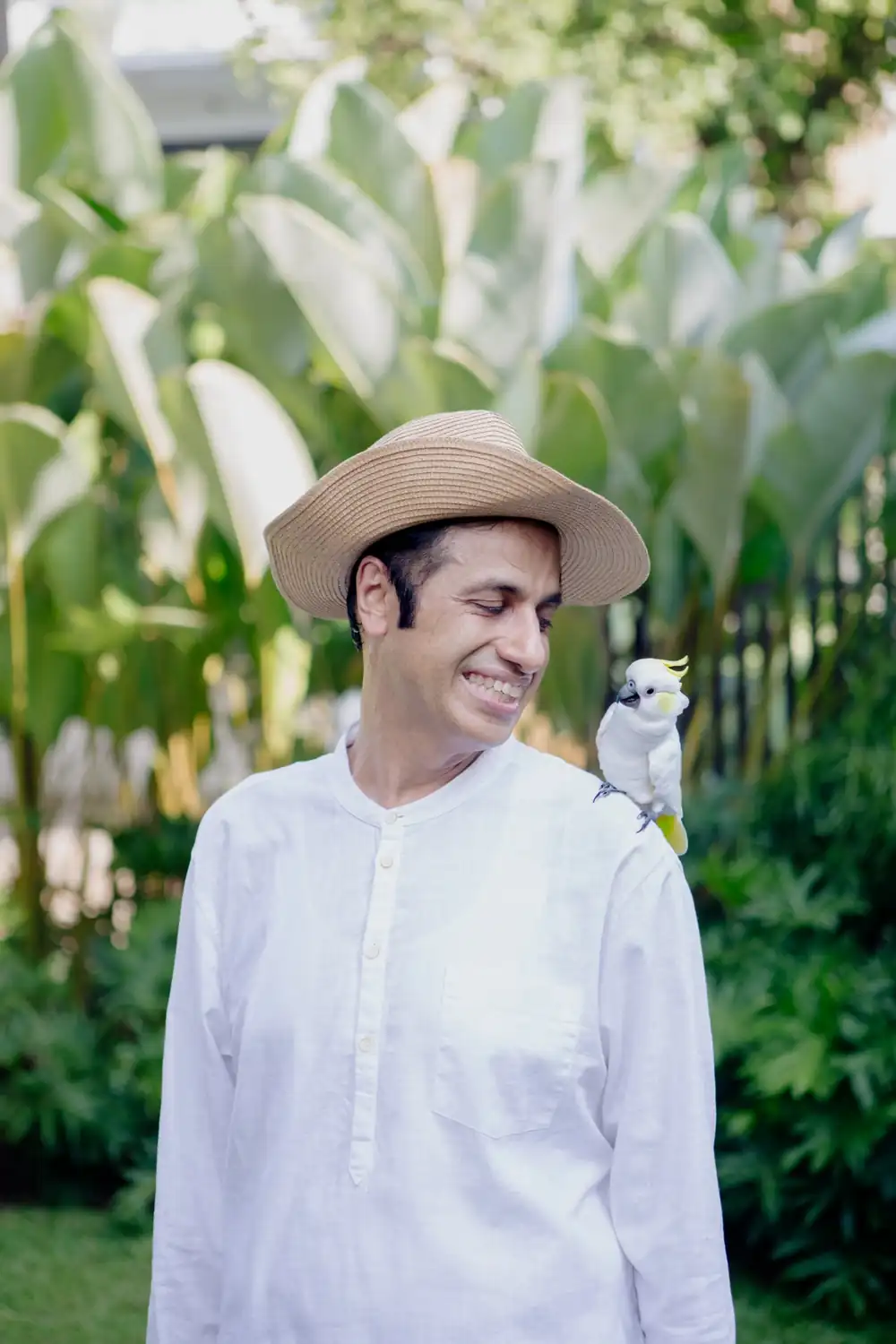 Dr. Suresh Devnani sharing a quiet moment with a cockatoo