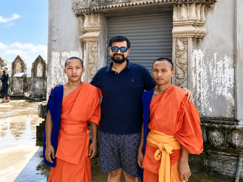 Dr. Suresh Devnani with two Buddhist monks during a spiritual journey